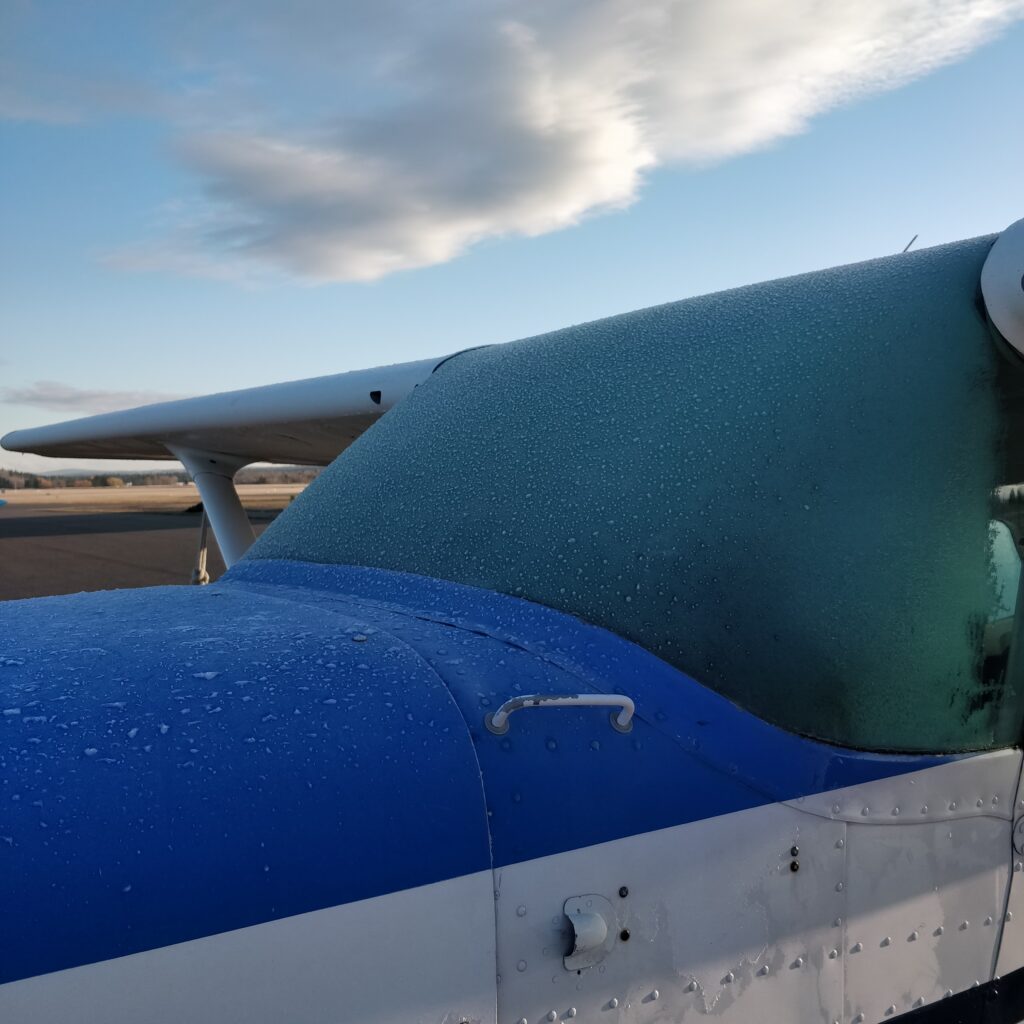 Airplane with ice and frost over the windscreen.